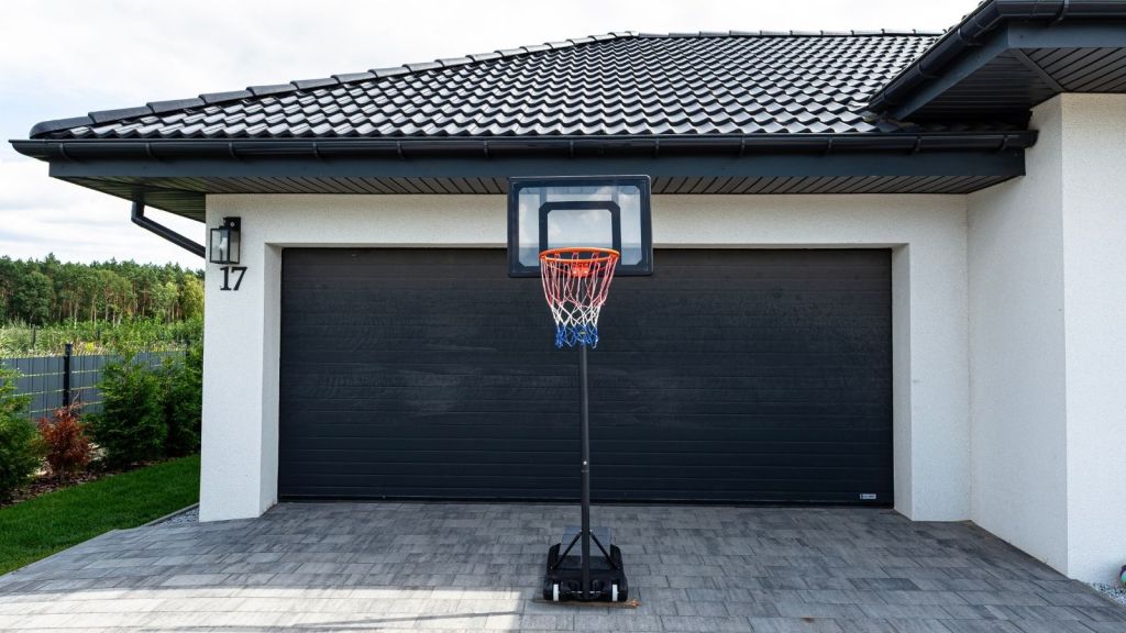 portable basketball hoop in the driveway of a house