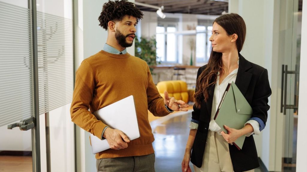 man talking to female coworker
