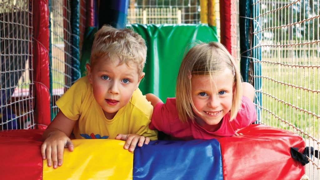 boy and girl playing at an amusement park