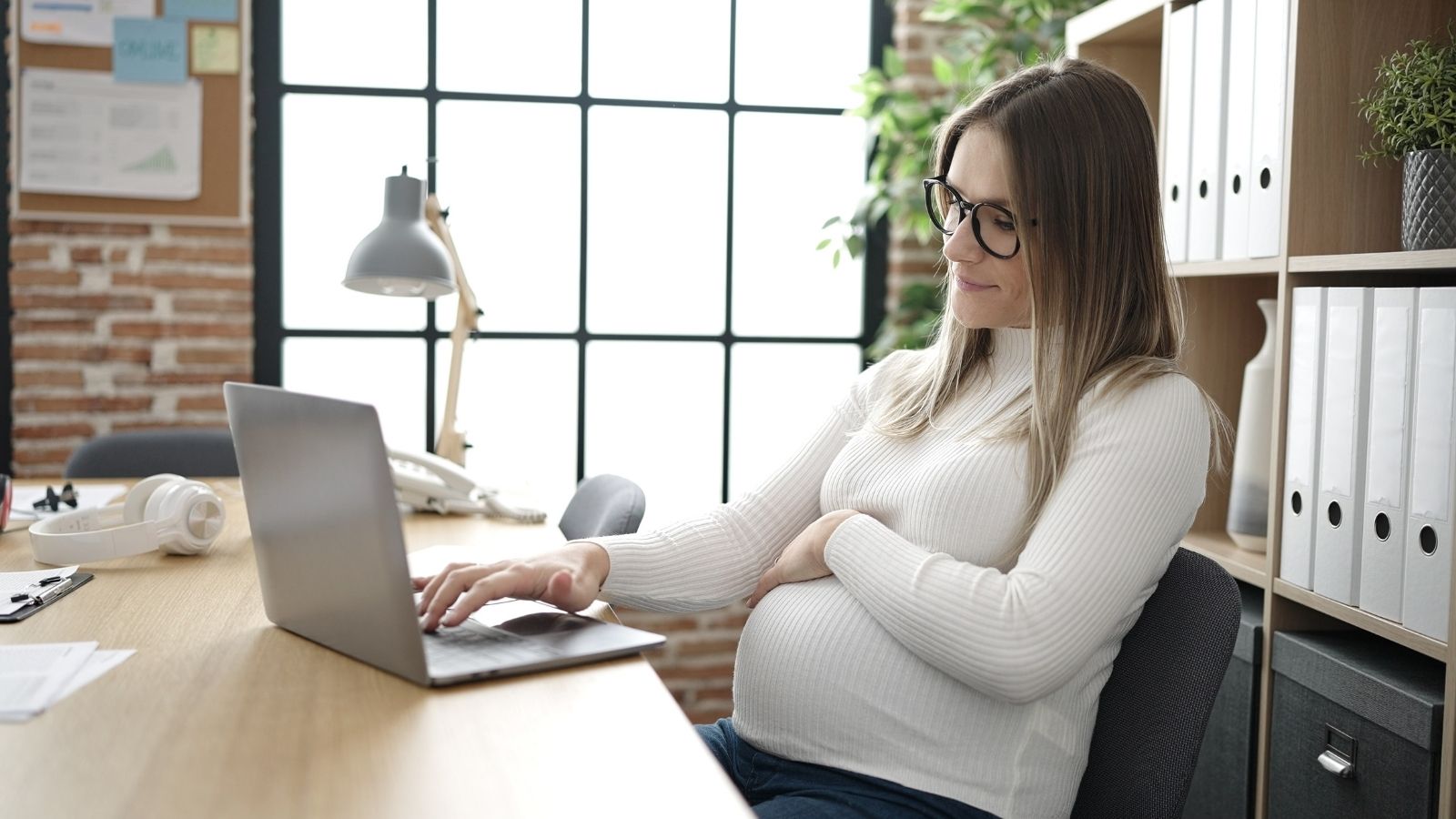 pregnant woman working in an office
