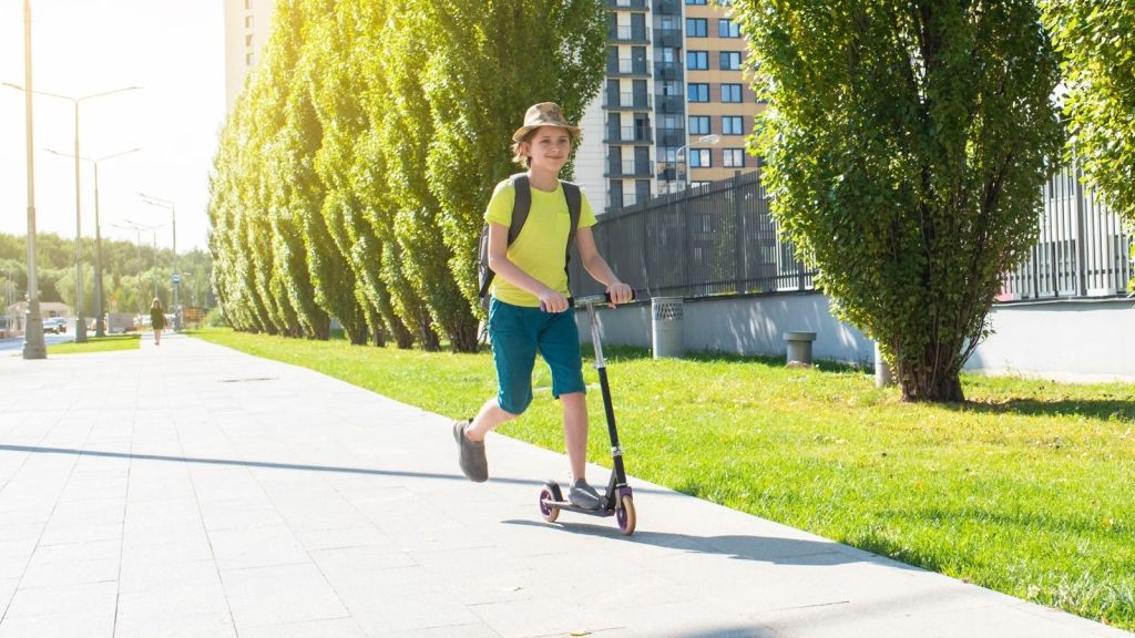 boy riding a scooter