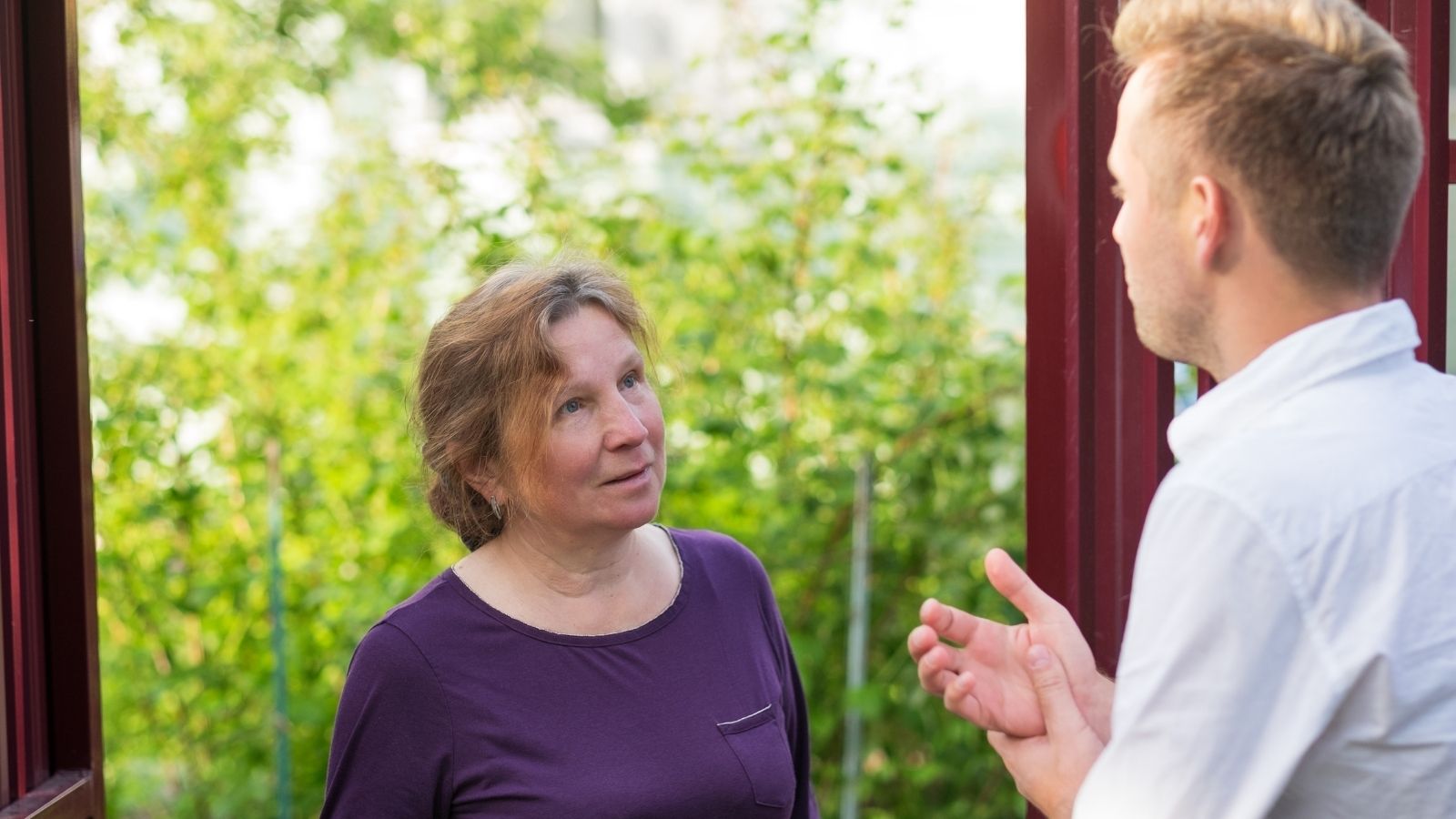 neighbors talk at the front door