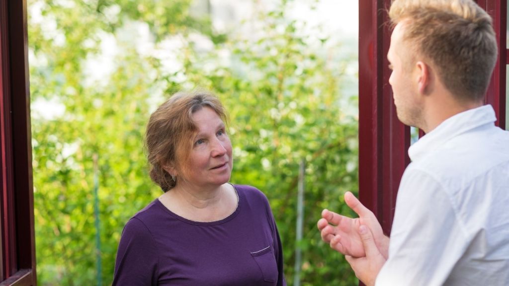 neighbors talk at the front door