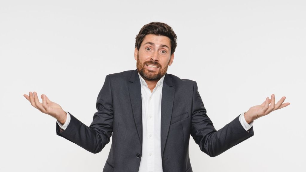 businessman shrugging and looking confused