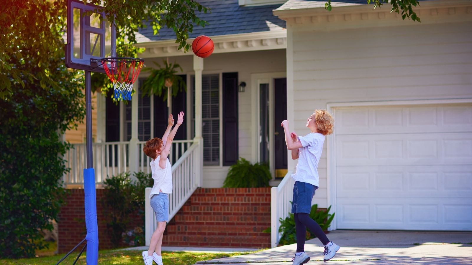 kids playing basketball in their driveway