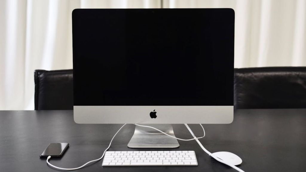 A desktop monitor on a table turned off