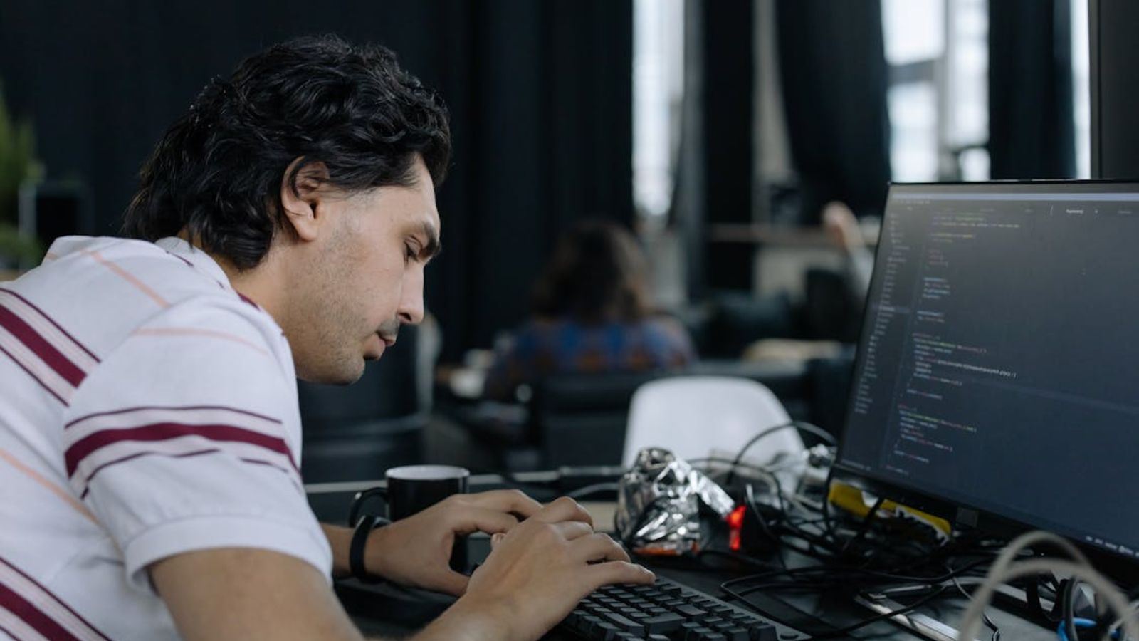 He Claimed the Company Database Just Randomly Deleted Itself—Until a Savvy IT Analyst Exposed the Ultimate Workplace Lie Man working in front of his computer