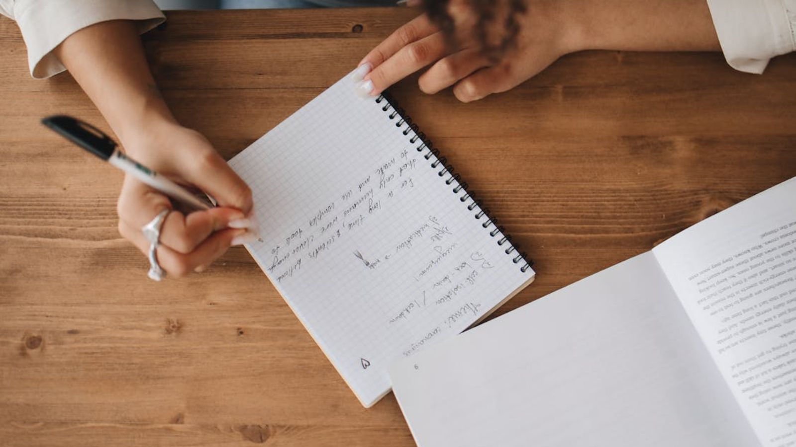 A Simple Request for Class Notes Turns Into a Heated Dispute Between Students Person writing notes on her notebook