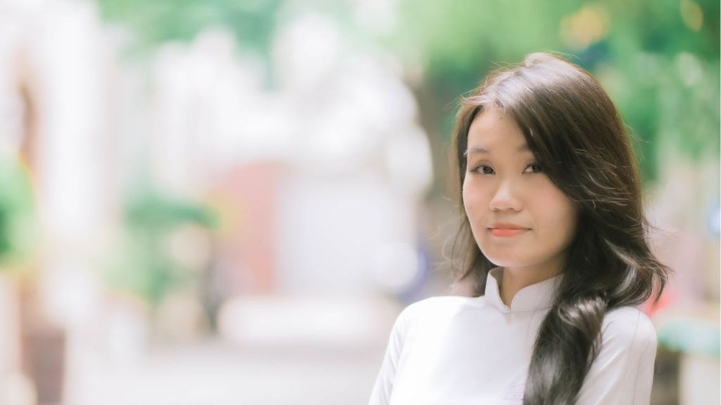 A Korean woman with a shy smile