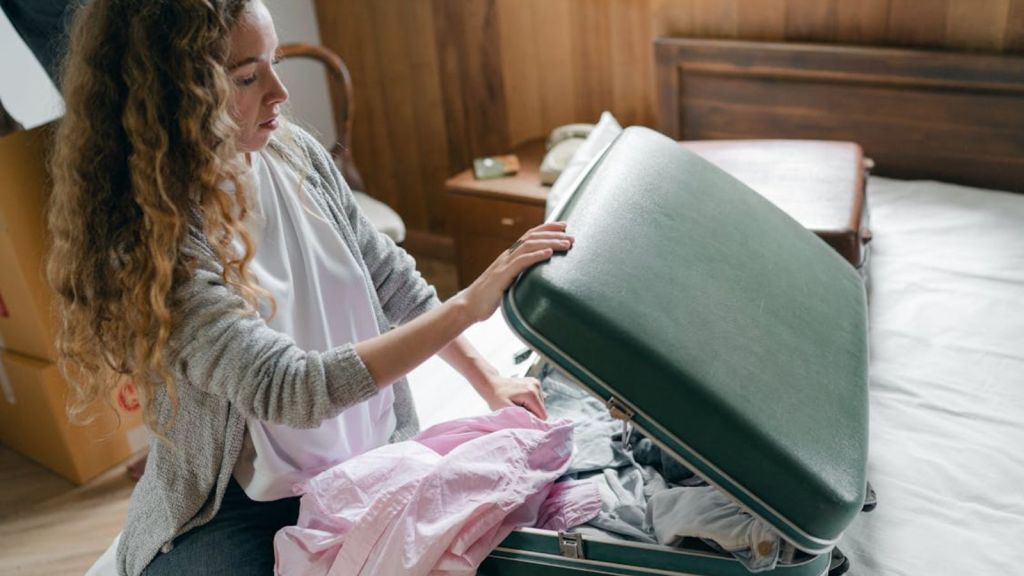 Woman preparing her luggage for a trip