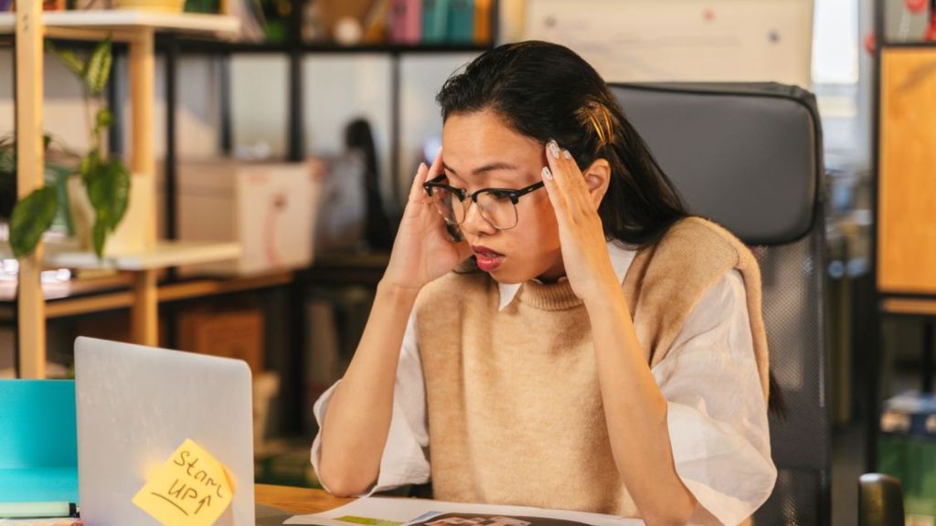 Woman in the office having a problem in front of her laptop