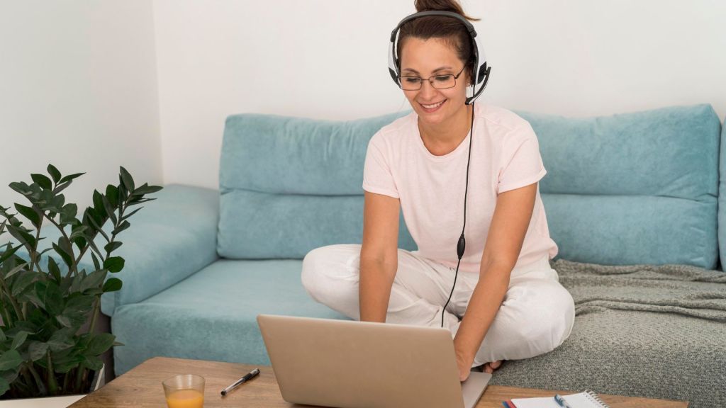 Woman smiling in front of her laptop at home
