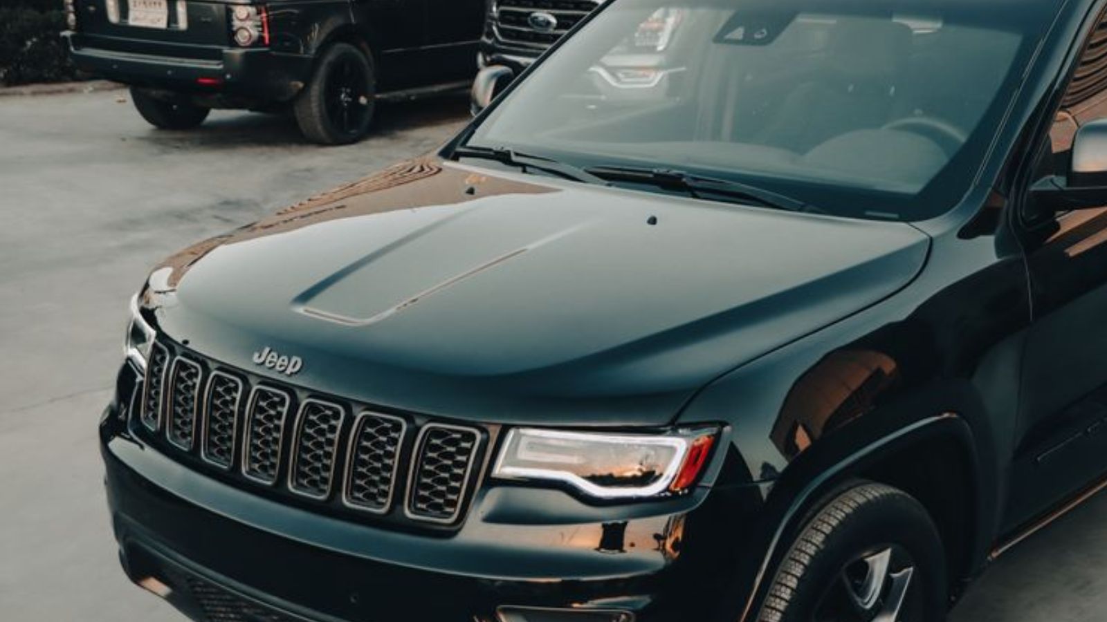 Woman Needs Reliable Car for School Runs, but Husband Wants to Trade It for an Old Truck A shiny black Jeep parked outdoors