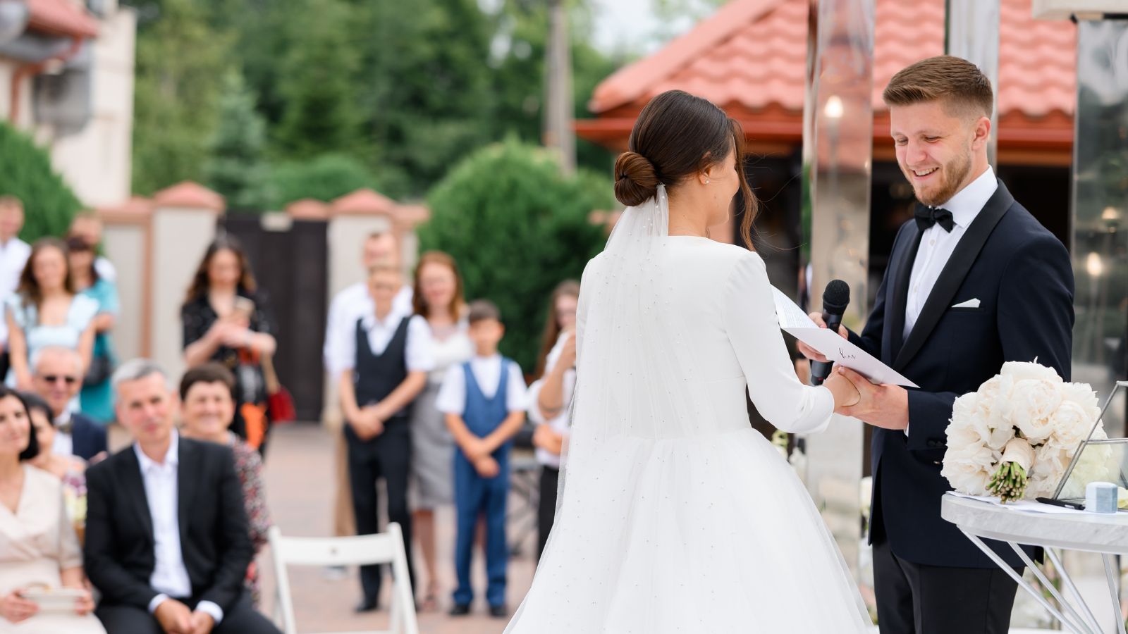 Wedding ceremony where bride and groom are exchanging vows and guests are watching