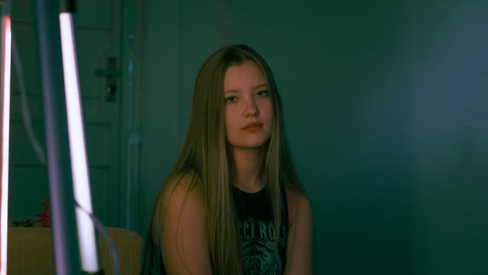 Teenager girl feeling sad in a dark room