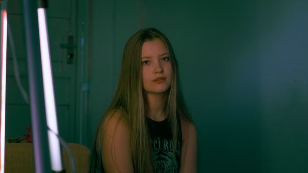 Teenager girl feeling sad in a dark room