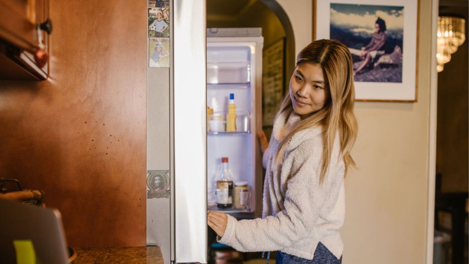 Fridge Dispute Arises After A Woman Labels Her Food To Stop An Exchange Student From Taking It Woman looking for food in the refrigerator