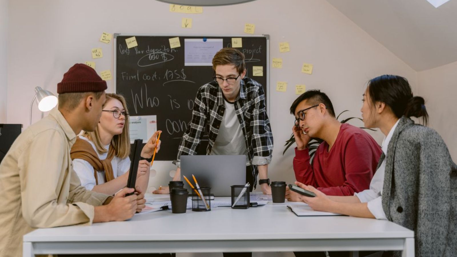 Employee Reflects on How Corporate Work Culture Impacts Mental Exhaustion Beyond Physical Labor Young professionals having a meeting in the office