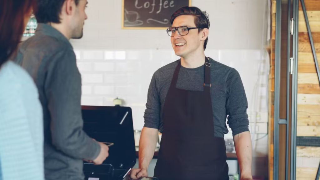 Store employee taking customers' orders