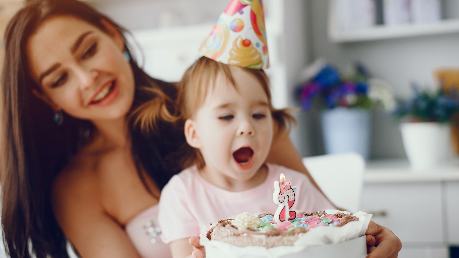 Tension Builds As A Woman Considers Not Attending Her Sister’s Stepkids’ Birthday Party After A Schedule Change Woman holding a little girl who's about to blow her birthday cake candle
