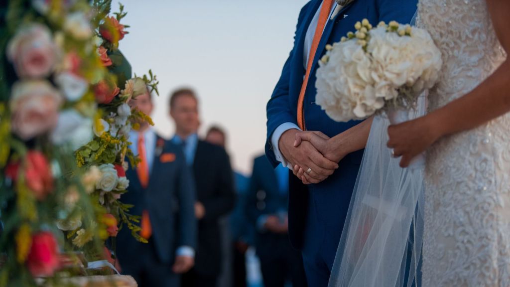 People attending and witnessing and solemn wedding with the bride and groom