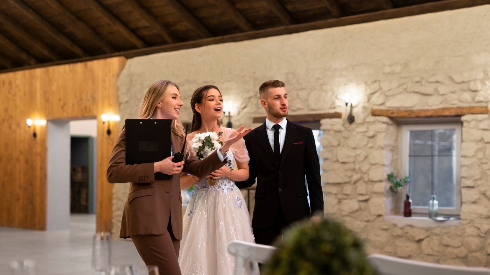 Wedding coordinator giving instructions to bride and groom on their wedding