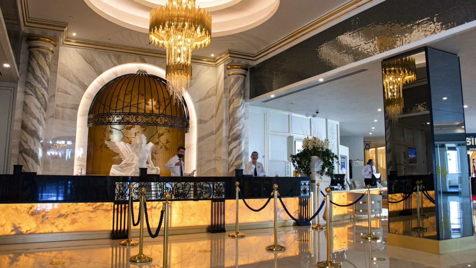 A huge hotel lobby with a beautiful chandelier