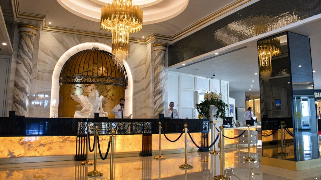 A huge hotel lobby with a beautiful chandelier