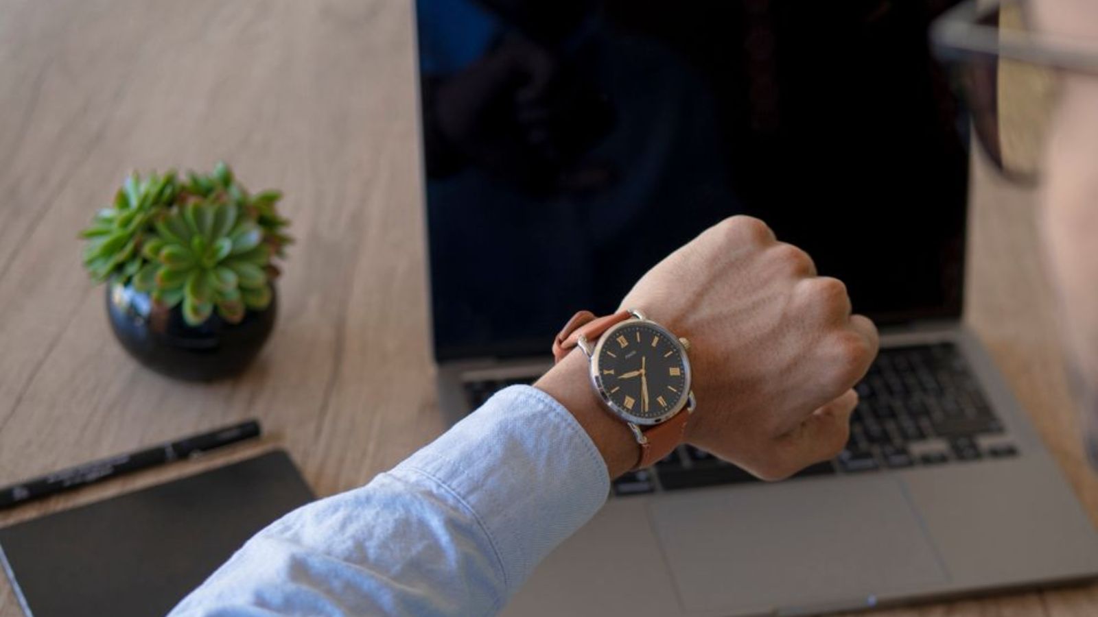 Hypocrisy in the Office: How One Employee Navigated Catching a Clock Gaming Coworker in the Act Man looking at his wrist watch while in the office