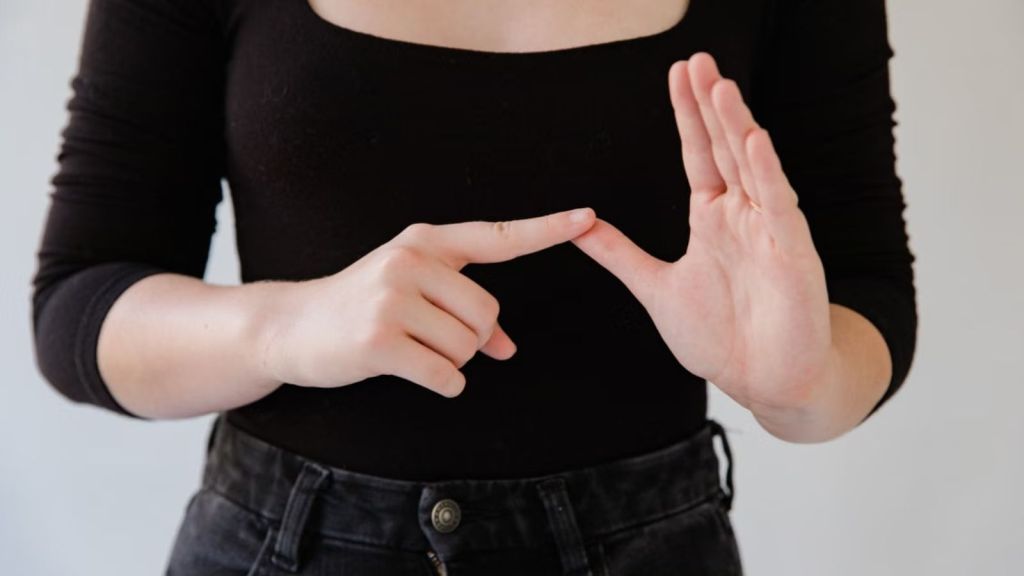 Person with black shirt doing sign language