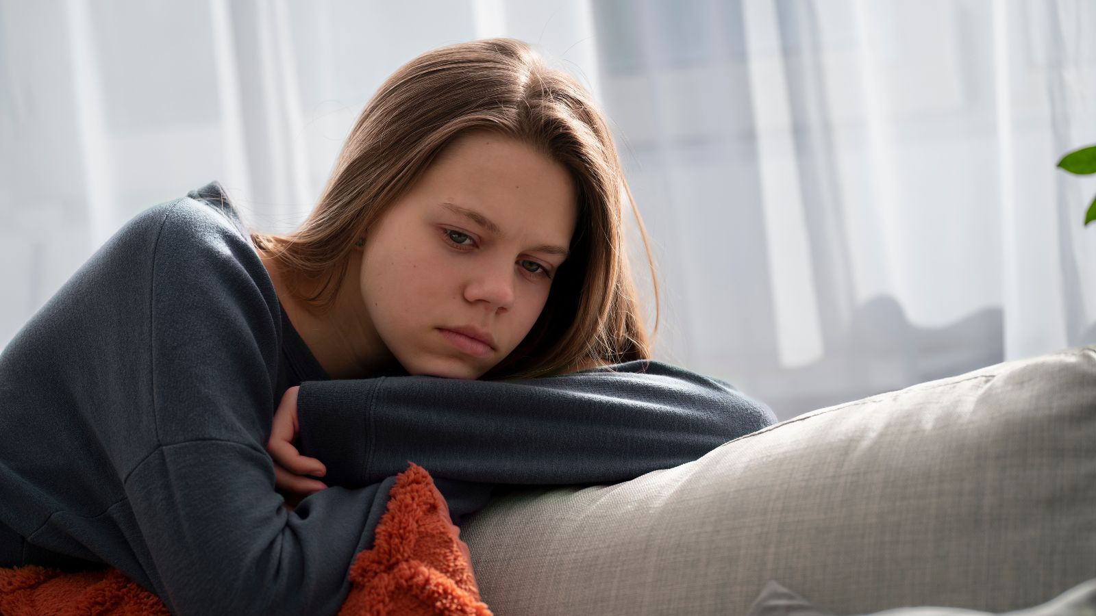 Teenage girl feeling sad and contemplating alone