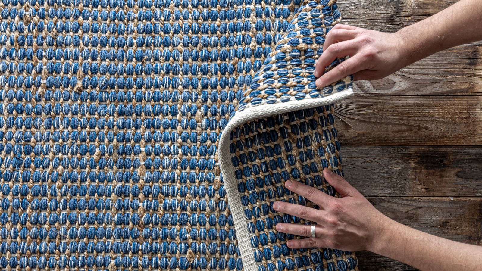 He Straightened a Neighbors Welcome Mat. They Reported Him for Tampering With Property Person's hand fixing the doormat