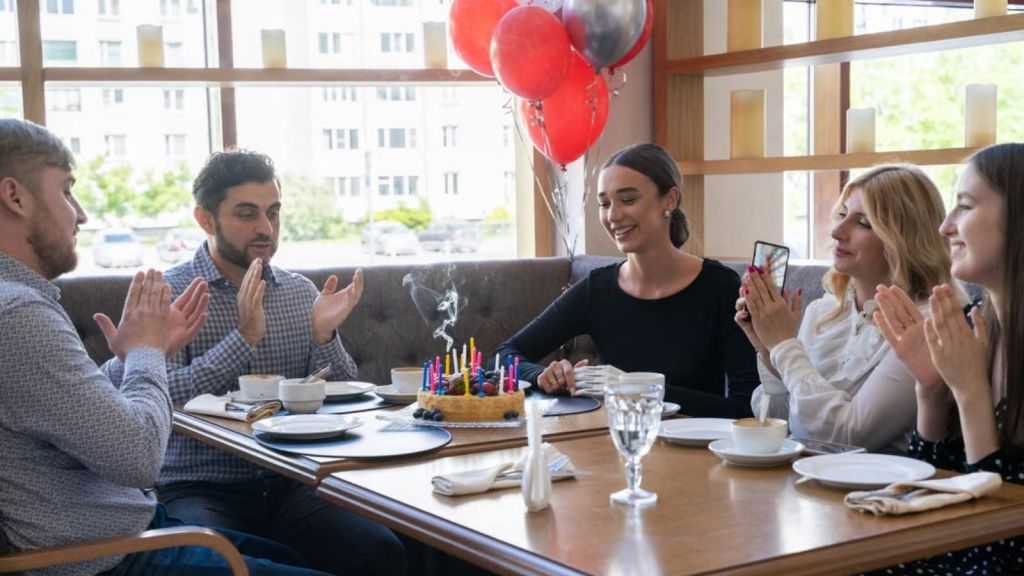 A groupf adults celebrating birthday in a restaurant