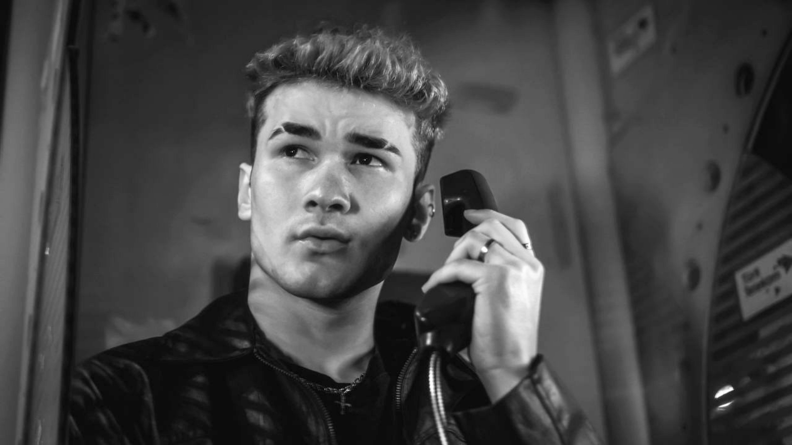 Contemplative man holds a vintage telephone