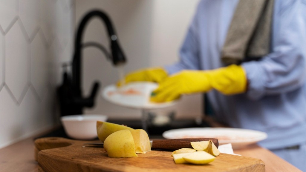 Woman doing the dishes with gloves