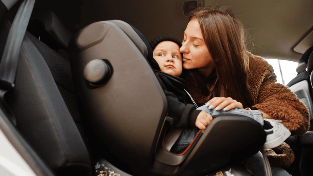 Mother and baby in baby car seat