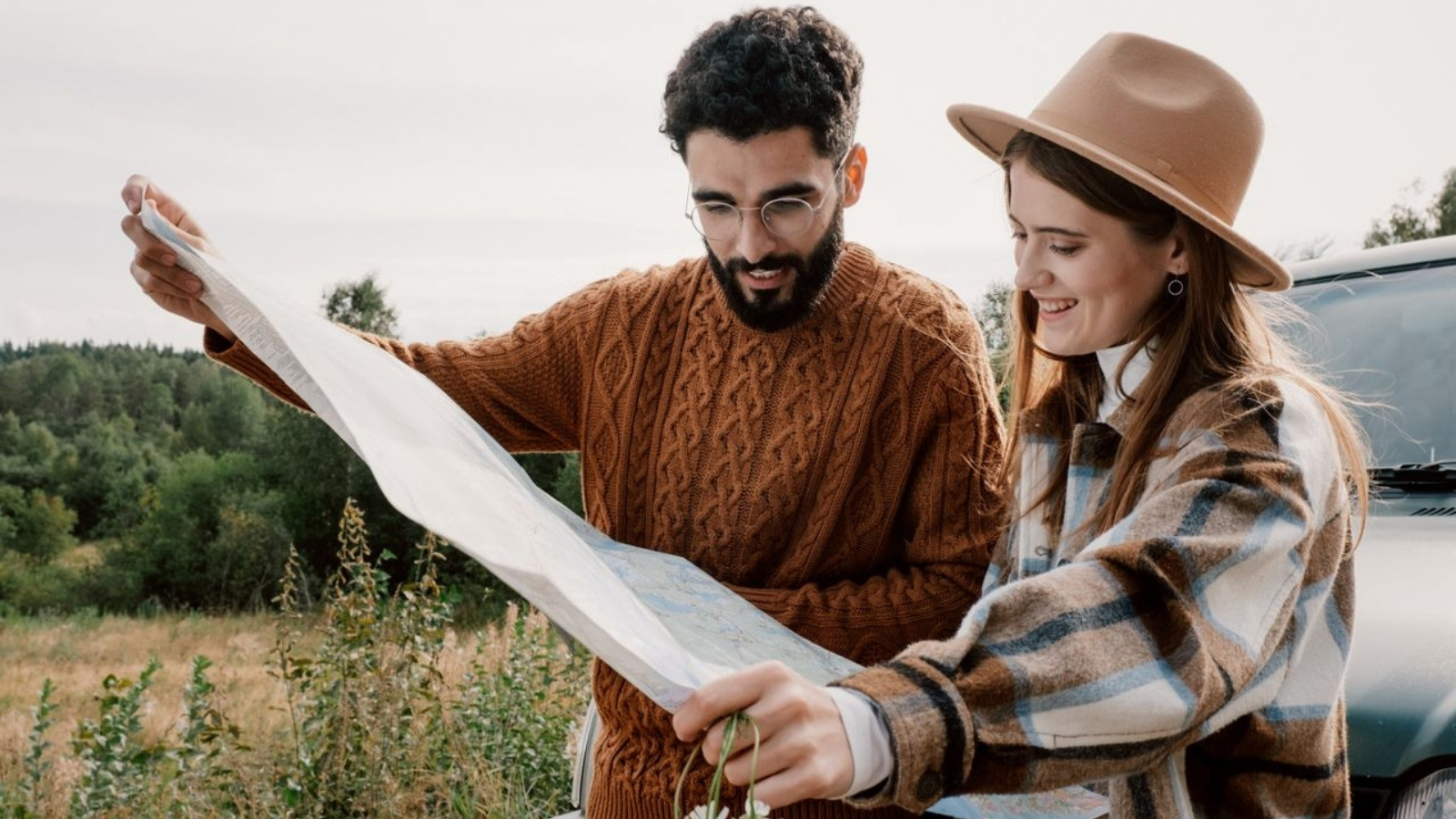 Couple looking at map during a roadtrip