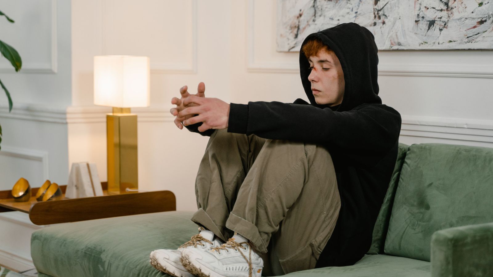 A Family Dispute Breaks Out After A Man Becomes Ill From Food Prepared By His Sister And Refuses To Eat There Again Sad boy in black hoodie