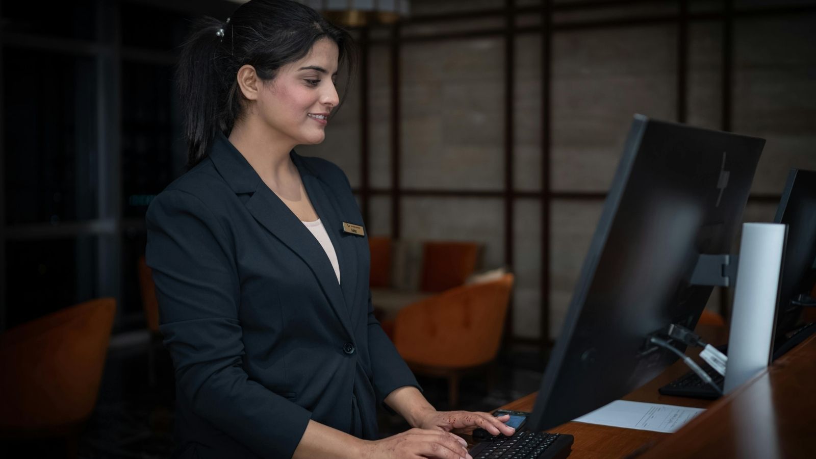 Hotel front desk worker typing