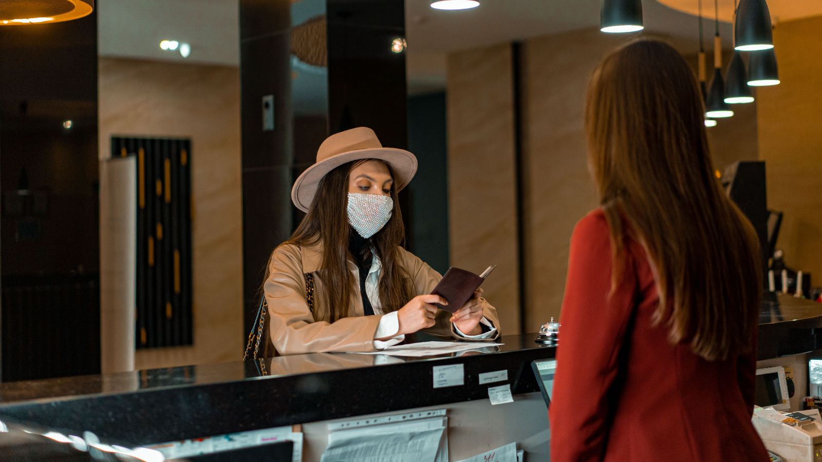 Woman in mask at a hotel reception