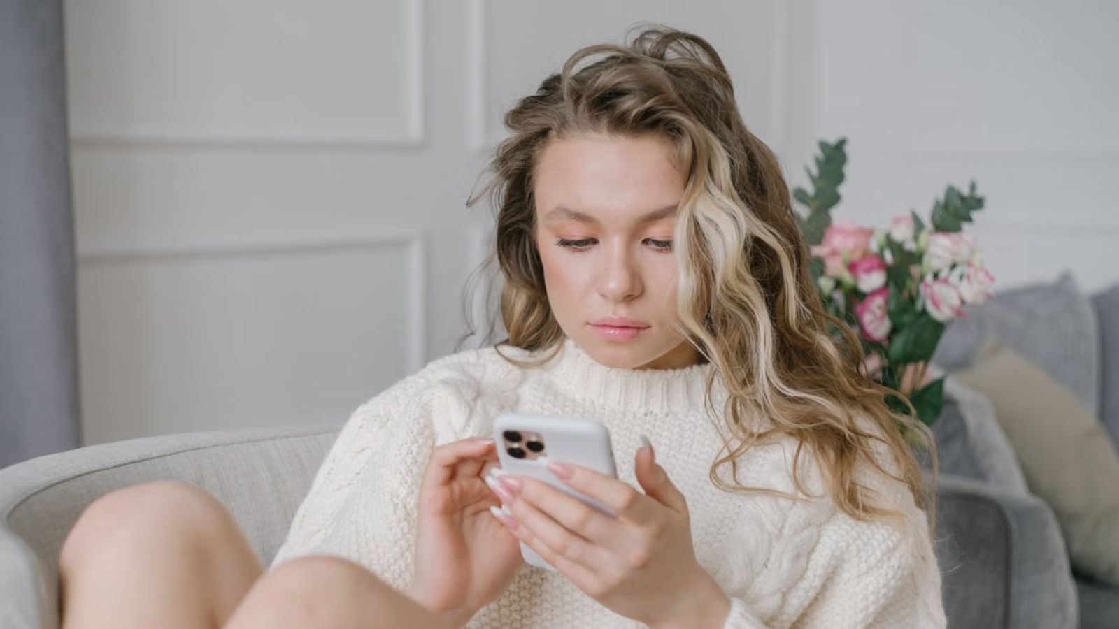 Woman looking at her phone with a serious face
