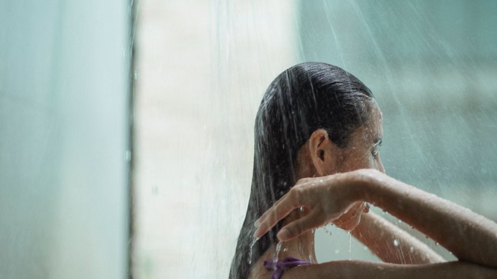 She Kept Her Late Night Routine After Moving Into a New Home — Then Learned It Had Been Causing Problems With Her Neighbors Woman showering in the bathroom
