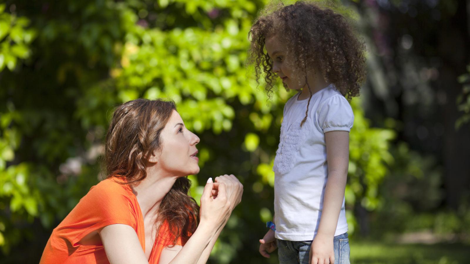 A Woman Tried To Comfort A Young Girl Crying In A Public Park, But The Girl Told Her To Leave Her Alone woman talking to a girl