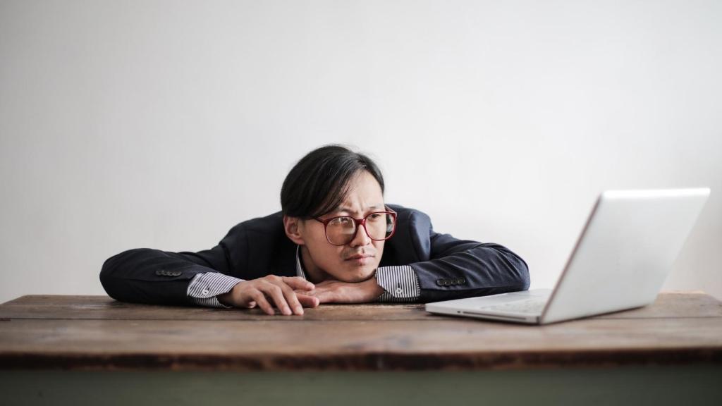 bored man laying head on desk