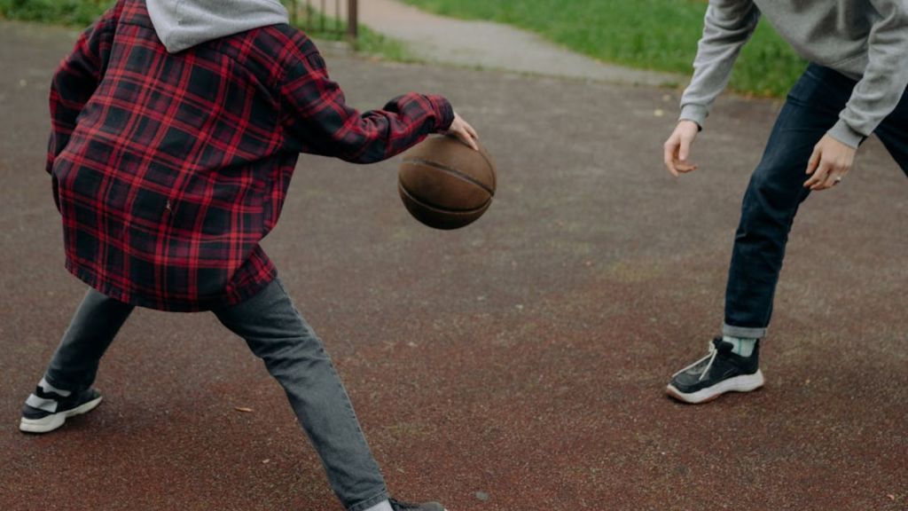 boys playing basketball outdoors