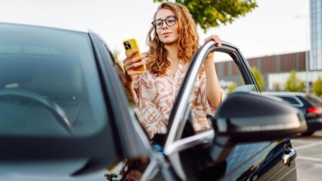 Woman at car with camera