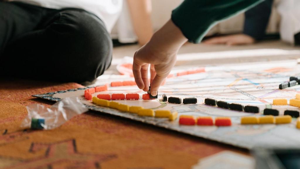 closeup of kids playing a board game
