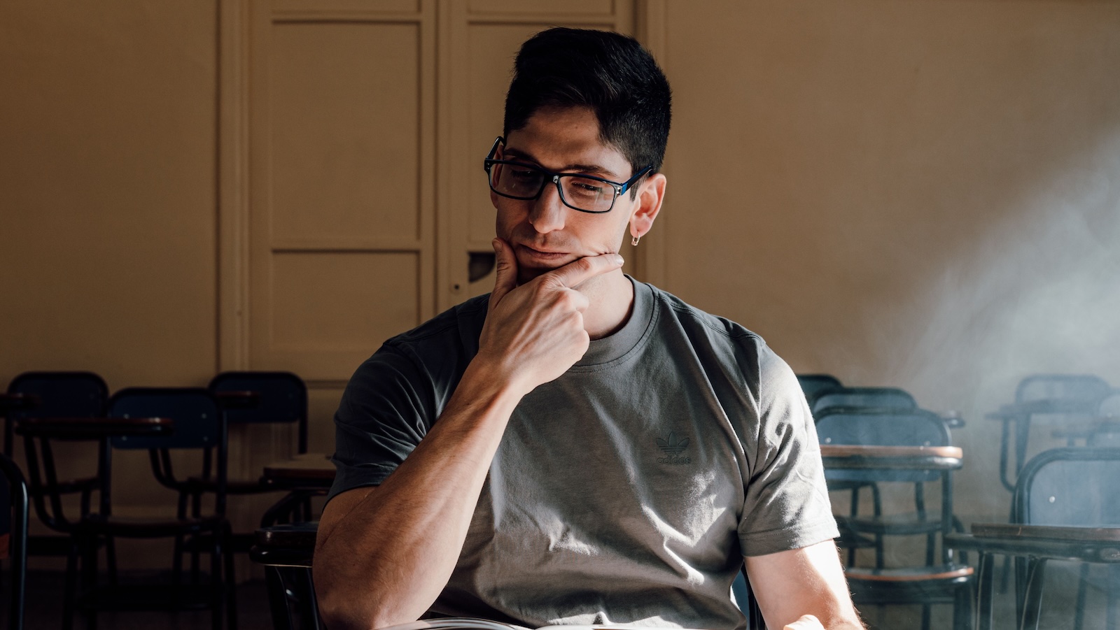 College Student Agrees to Meet Two Strangers for a Video Project, Then Reconsiders After Talking to His Mom college student looking pensive studying