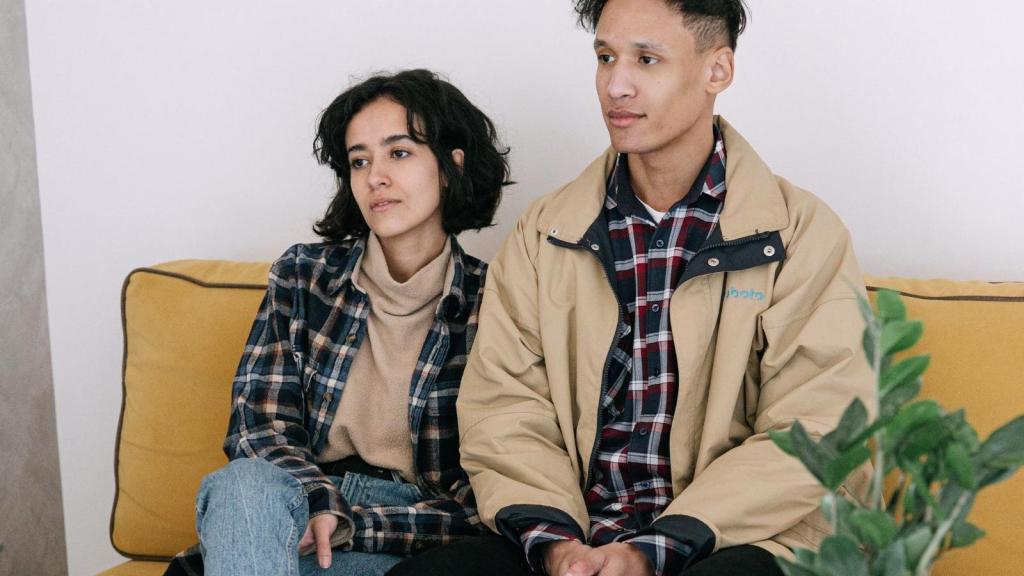 couple sitting on yellow couch