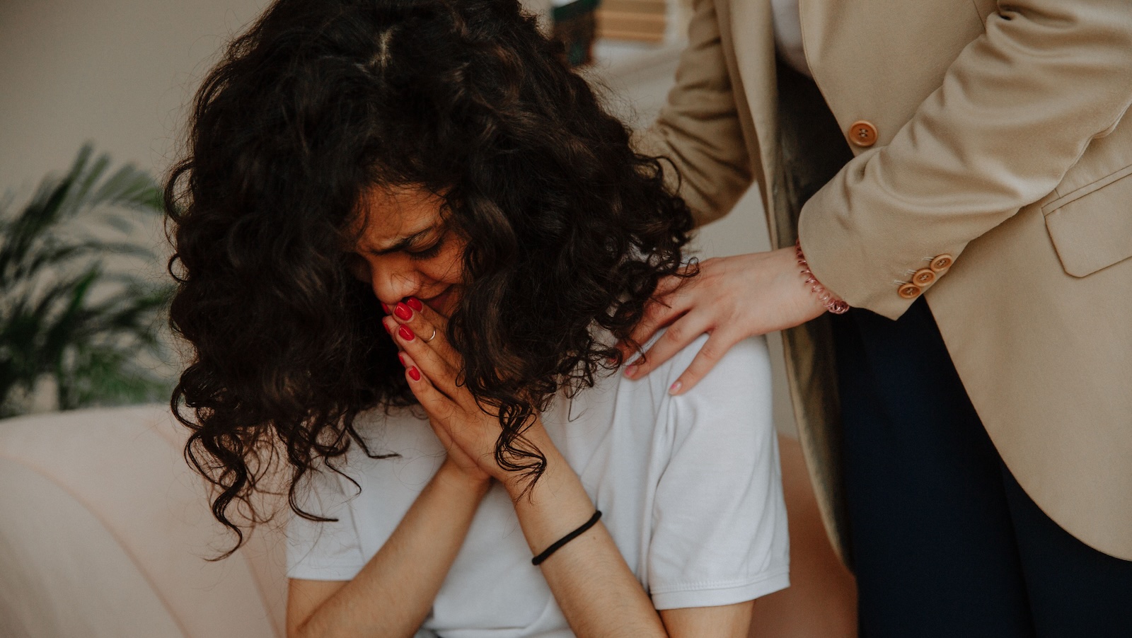 Coworker Kept Making Racist Comments About Her Relationship, Then Burst Into Tears When She Fired Back woman crying and someone trying to console her